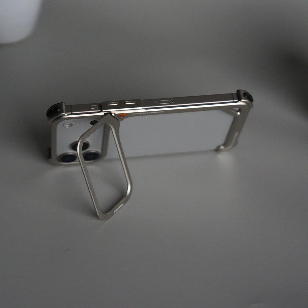 iPhone 17 Pro 9-Shaped Frameless Metal Bumper Case with Hidden Lens Stand | Shockproof Aviation-Grade Alloy Frame